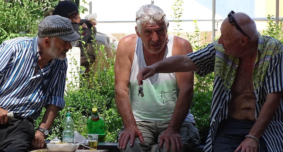 Older men on a park bench in central Plovdiv, the Bulgarian retirement reality that British pensioners settle into