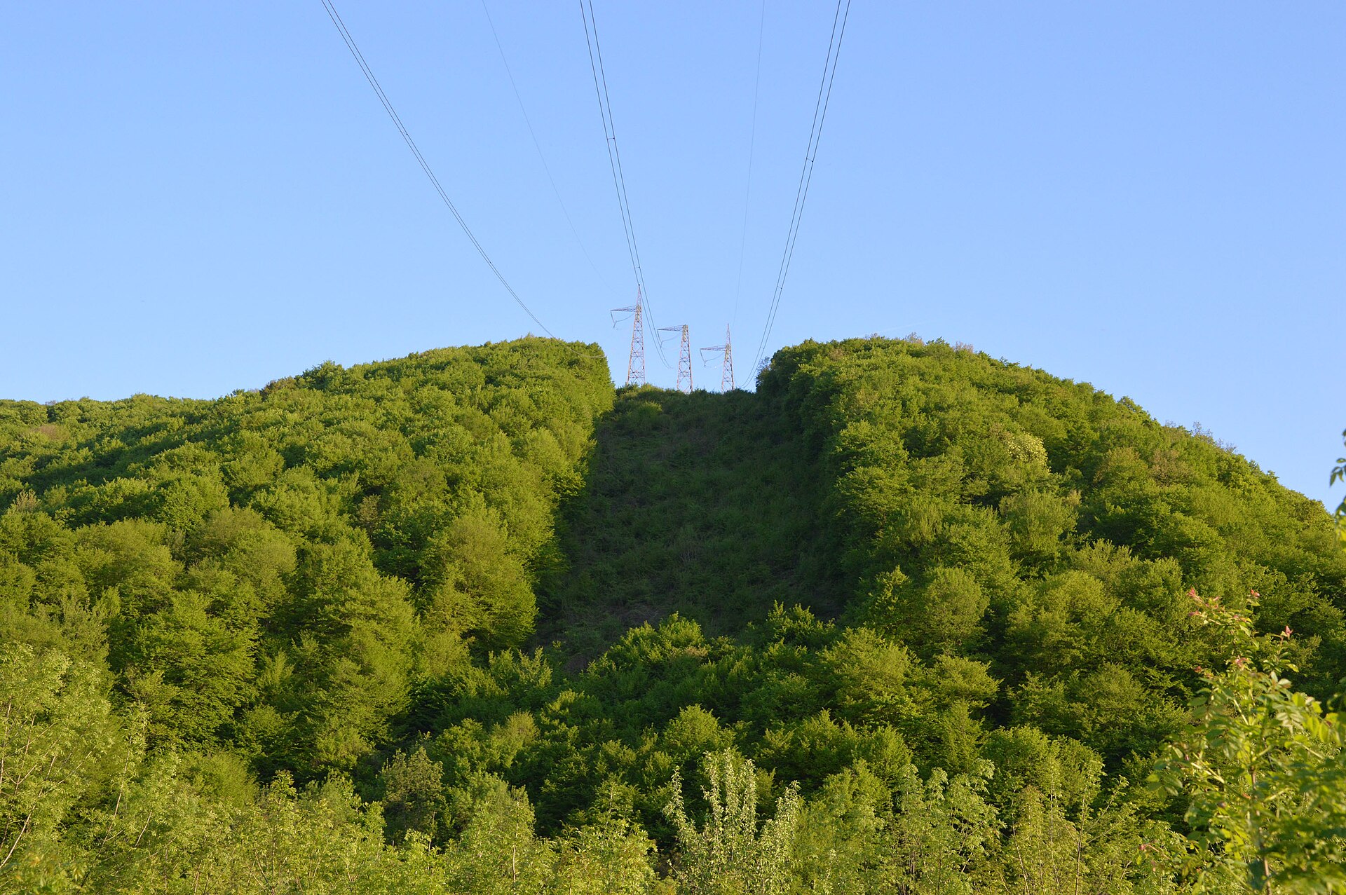 High-voltage electricity pylons crossing rural Bulgaria near Vrachesh