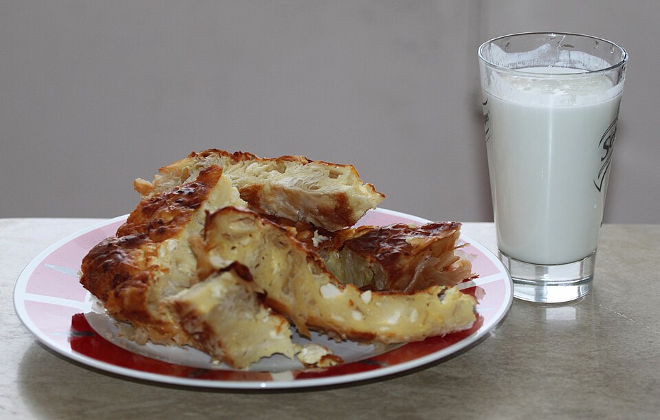 A plate of banitsa, the traditional Bulgarian filo pastry breakfast, served with yoghurt